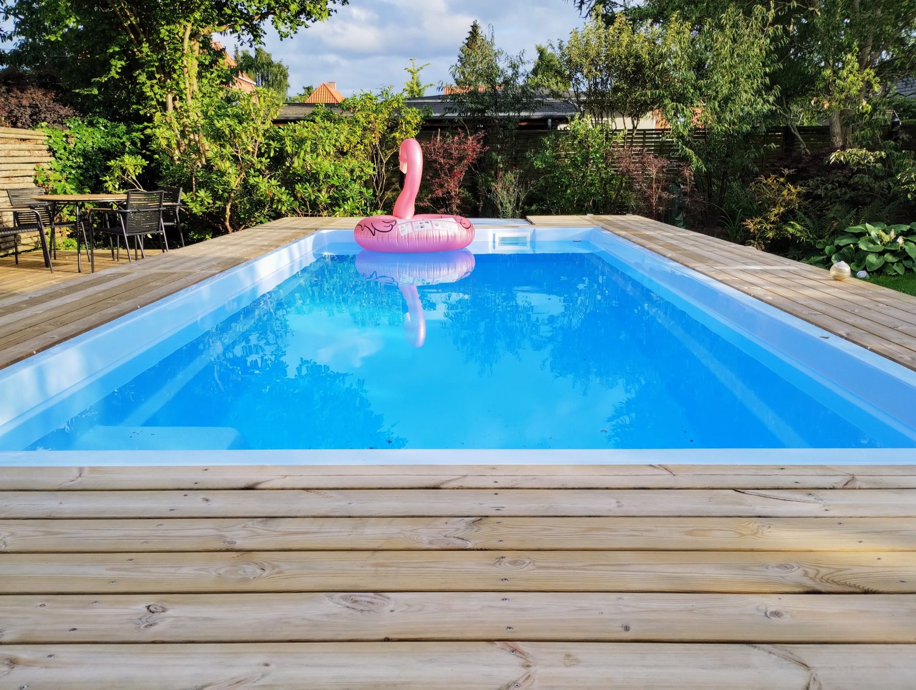 Finished pool on a summer day with a flamingo float