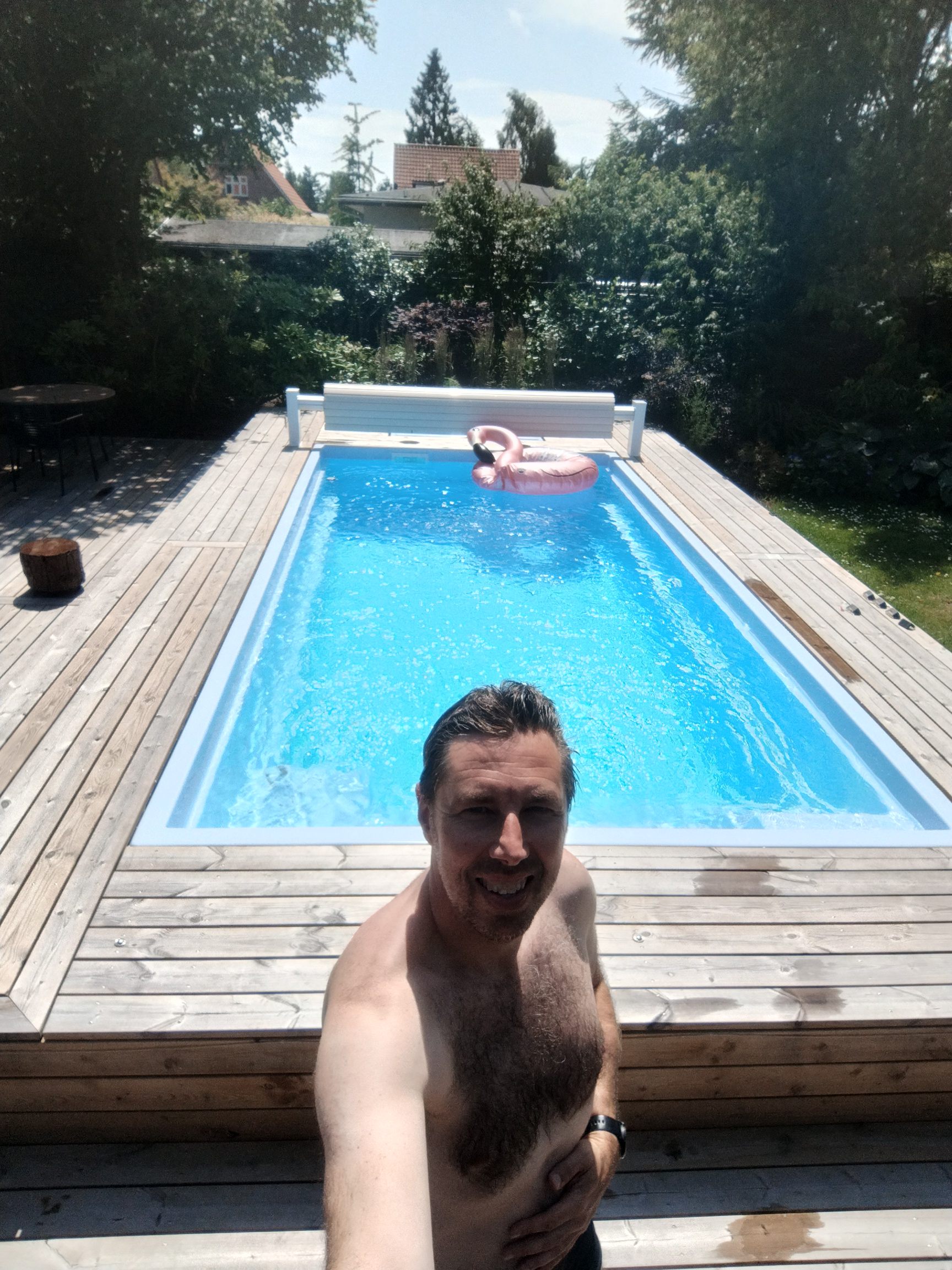 Happy pool owner in front of the finished pool
